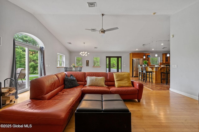 living area with light wood finished floors, a ceiling fan, recessed lighting, baseboards, and high vaulted ceiling