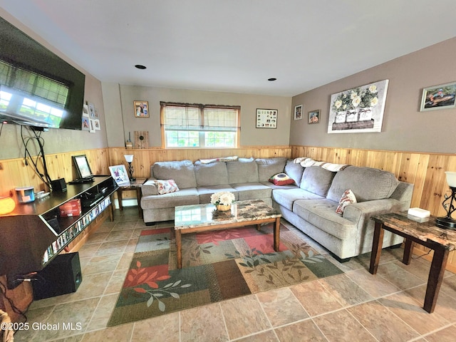 living area featuring wainscoting and wood walls