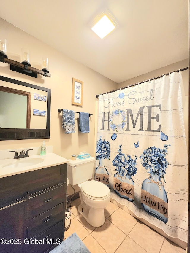 full bath with tile patterned floors, toilet, vanity, and curtained shower