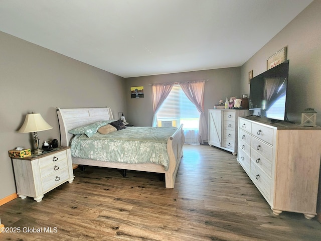 bedroom featuring dark wood-style flooring and baseboards