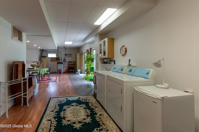 1435 Webster St, Malone, NY 12953 - laundry area featuring washer and dryer, light wood finished floors, and water heater