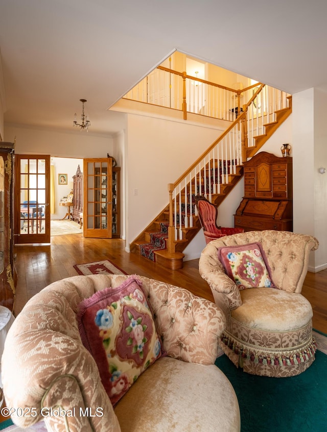 1435 Webster St, Malone, NY 12953 - living room featuring hardwood / wood-style flooring, stairs, and a chandelier