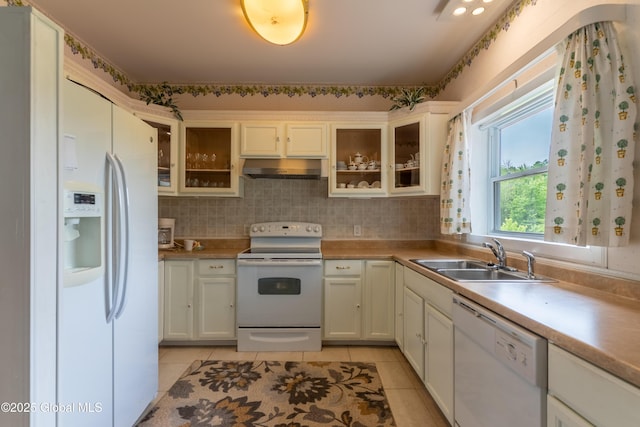 1435 Webster St, Malone, NY 12953 - kitchen featuring white appliances, under cabinet range hood, light tile patterned flooring, and glass insert cabinets