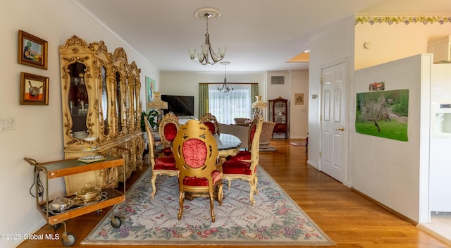 1435 Webster St, Malone, NY 12953 - dining space featuring a chandelier and light wood finished floors