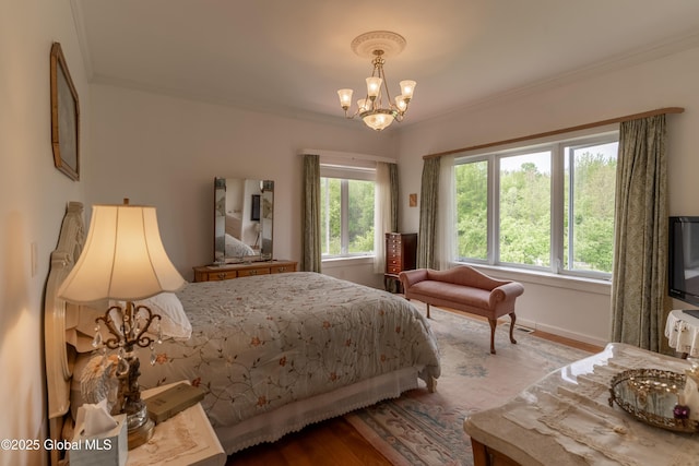 1435 Webster St, Malone, NY 12953 - bedroom with ornamental molding, a chandelier, and wood finished floors