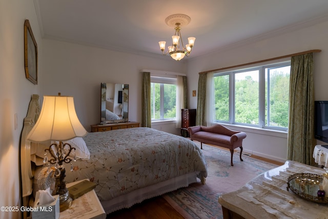 1435 Webster St, Malone, NY 12953 - bedroom featuring crown molding, a chandelier, and wood finished floors