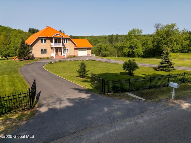 1435 Webster St, Malone, NY 12953 - view of front facade featuring asphalt driveway, a garage, and a forest view