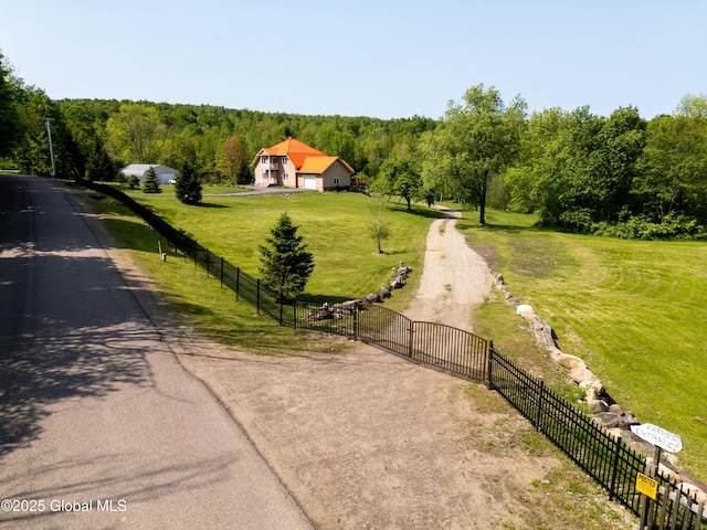 1435 Webster St, Malone, NY 12953 - view of asphalt driveway featuring a view of trees, a gate, and a view of rural / pastoral area