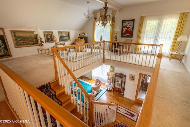1435 Webster St, Malone, NY 12953 - stairs with a chandelier, plenty of natural light, vaulted ceiling, carpet flooring, and ornamental molding