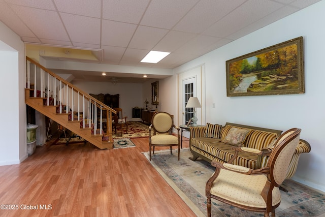 1435 Webster St, Malone, NY 12953 - living area with wood finished floors, stairs, and a paneled ceiling