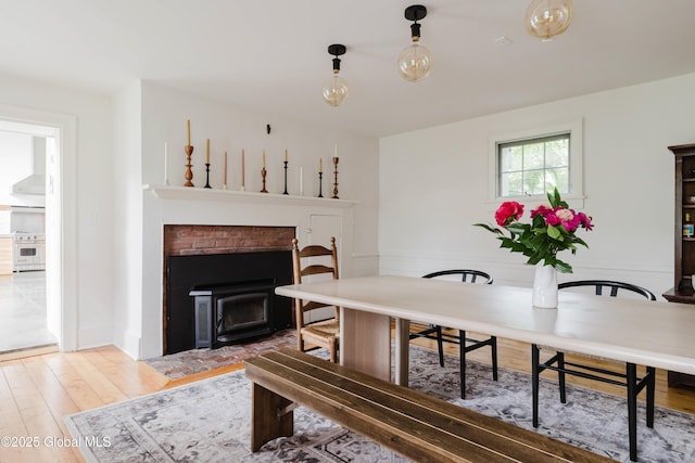 632 Albany Tpke, Chatham, NY 12136 - dining room featuring a fireplace with flush hearth and wood finished floors