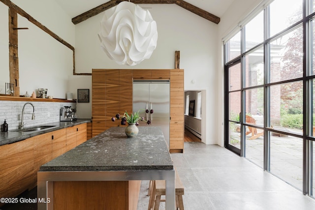 632 Albany Tpke, Chatham, NY 12136 - kitchen with high vaulted ceiling, a sink, open shelves, decorative backsplash, and beamed ceiling