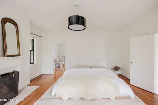 632 Albany Tpke, Chatham, NY 12136 - bedroom with light wood-style flooring and a fireplace