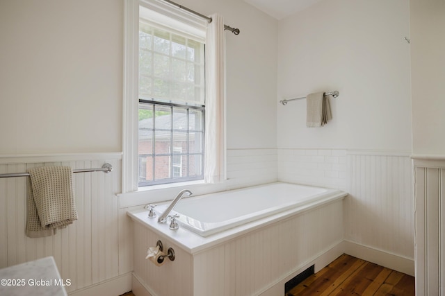 632 Albany Tpke, Chatham, NY 12136 - full bath with a wainscoted wall, a bath, and wood finished floors