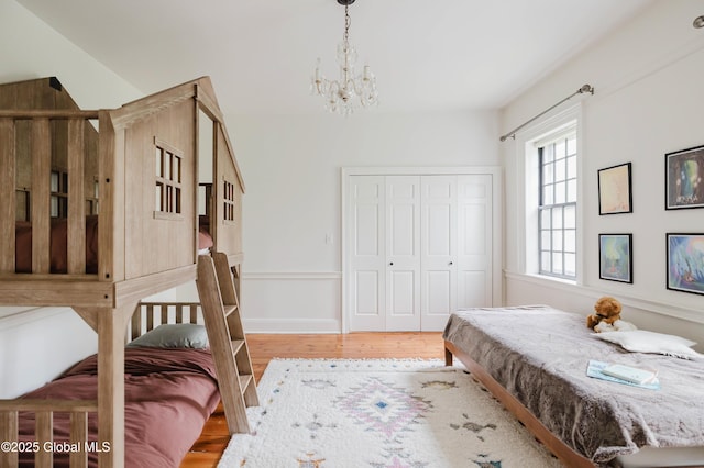 632 Albany Tpke, Chatham, NY 12136 - bedroom featuring a chandelier, wood finished floors, and a closet