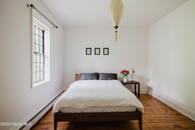 632 Albany Tpke, Chatham, NY 12136 - bedroom with a baseboard radiator, hardwood / wood-style floors, and baseboards