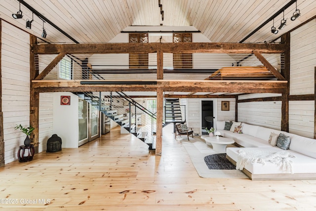 632 Albany Tpke, Chatham, NY 12136 - living area with wood walls, hardwood / wood-style flooring, wood ceiling, stairway, and high vaulted ceiling
