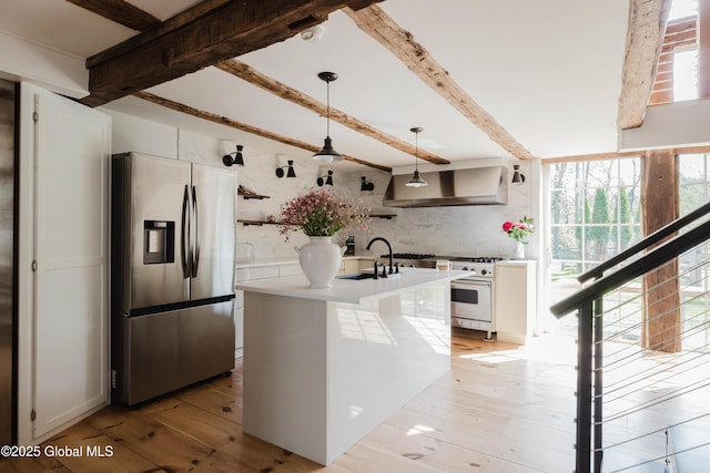 632 Albany Tpke, Chatham, NY 12136 - kitchen featuring stainless steel fridge with ice dispenser, a sink, wall chimney exhaust hood, beam ceiling, and gas stove
