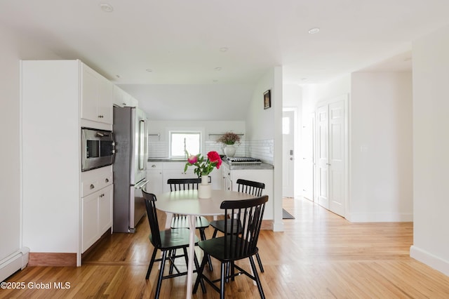 632 Albany Tpke, Chatham, NY 12136 - dining space with baseboard heating, light wood-type flooring, and baseboards