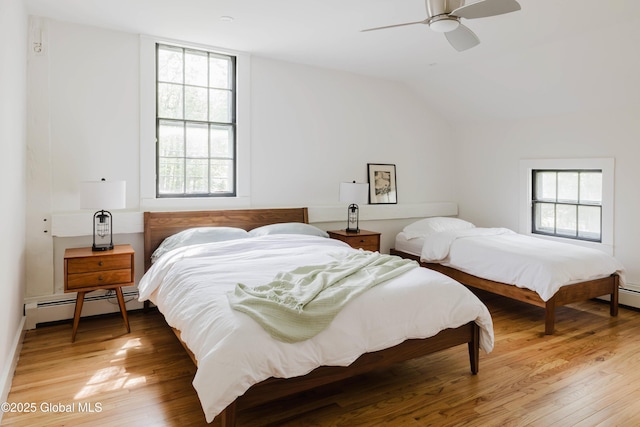 632 Albany Tpke, Chatham, NY 12136 - bedroom with a baseboard heating unit, light wood finished floors, ceiling fan, and lofted ceiling
