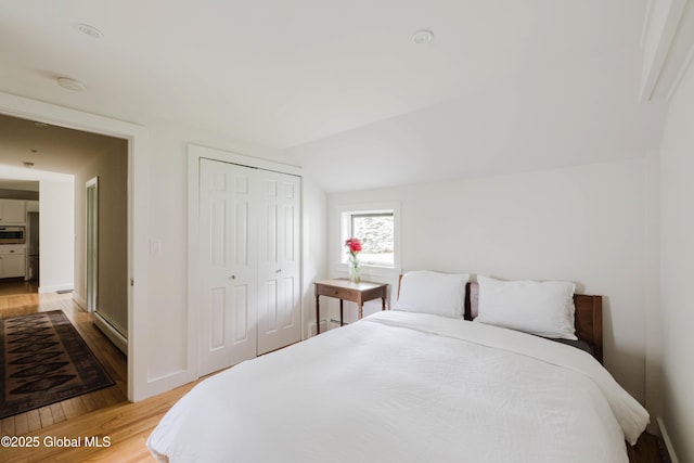 632 Albany Tpke, Chatham, NY 12136 - bedroom with light wood finished floors, a closet, lofted ceiling, and baseboards