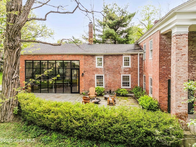 632 Albany Tpke, Chatham, NY 12136 - back of property with a chimney, a patio, brick siding, and roof with shingles