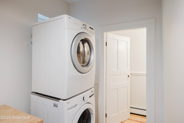 632 Albany Tpke, Chatham, NY 12136 - laundry room featuring stacked washer / dryer, a baseboard heating unit, and wainscoting