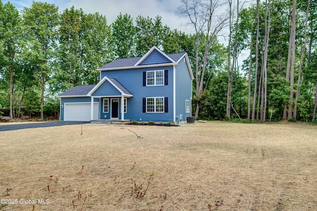 traditional home featuring a garage, gravel driveway, cooling unit, and view of scattered trees