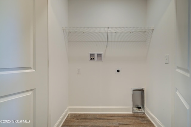 laundry area with electric dryer hookup, hookup for a washing machine, wood finished floors, and baseboards