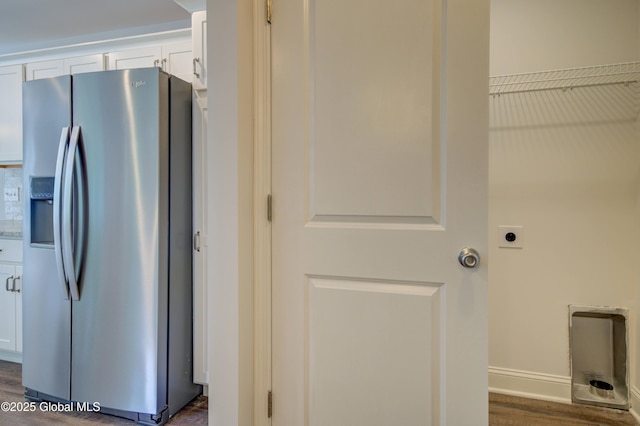 laundry area with baseboards and dark wood finished floors