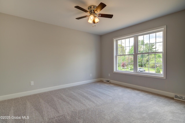 spare room featuring baseboards, carpet floors, and ceiling fan