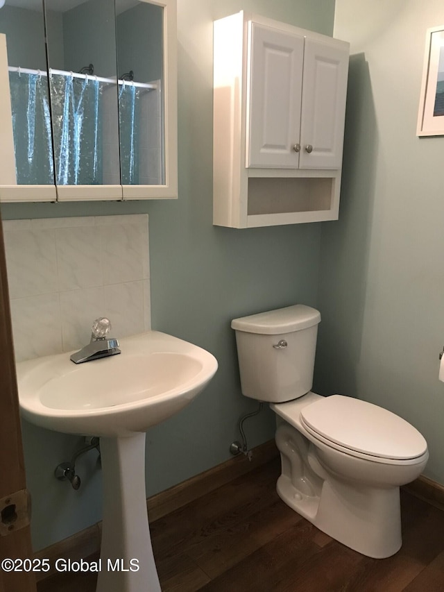 24 Fairmount Dr, Wilton, NY 12831 - bathroom with wood finished floors, toilet, a shower with shower curtain, and tasteful backsplash