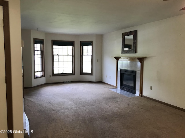 24 Fairmount Dr, Wilton, NY 12831 - unfurnished living room featuring carpet, a tile fireplace, and baseboards