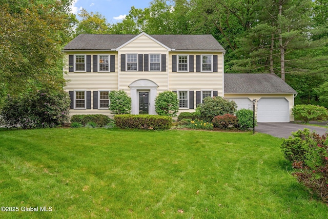 55 Journey Ln, Bethlehem, NY 12077 - colonial home with asphalt driveway, an attached garage, a front yard, and a shingled roof