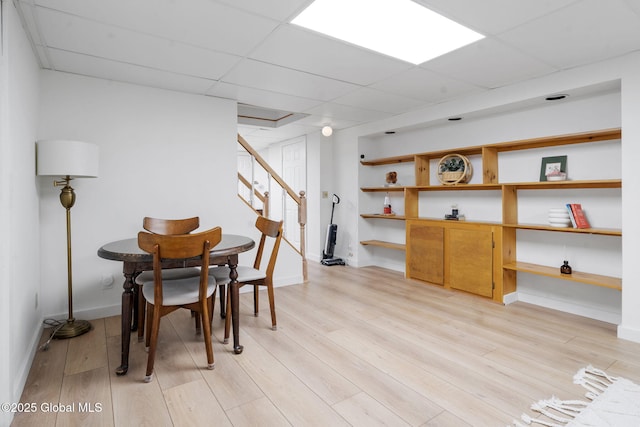 55 Journey Ln, Bethlehem, NY 12077 - dining room with light wood-type flooring, stairway, baseboards, and a paneled ceiling