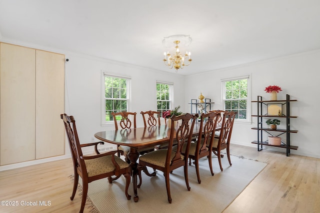 55 Journey Ln, Bethlehem, NY 12077 - dining area featuring light wood-style flooring, a chandelier, ornamental molding, and baseboards