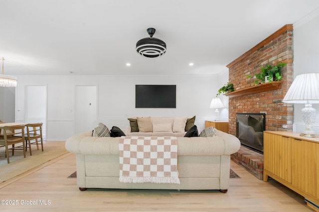 55 Journey Ln, Bethlehem, NY 12077 - living room featuring light wood-style floors, a brick fireplace, crown molding, and recessed lighting