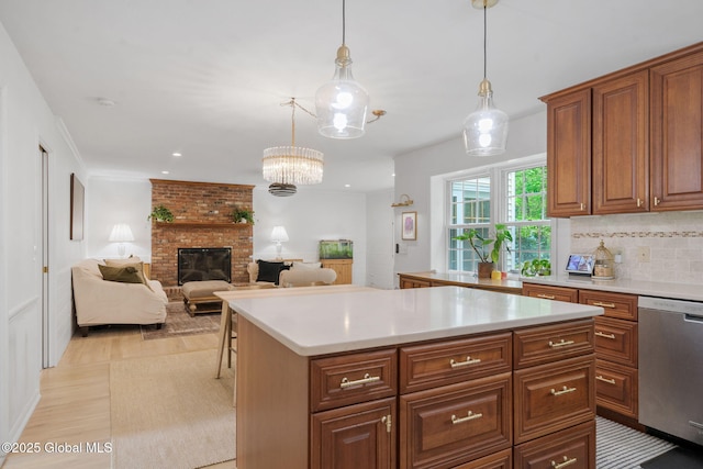 55 Journey Ln, Bethlehem, NY 12077 - kitchen with dishwasher, light countertops, light wood-style floors, a brick fireplace, and backsplash
