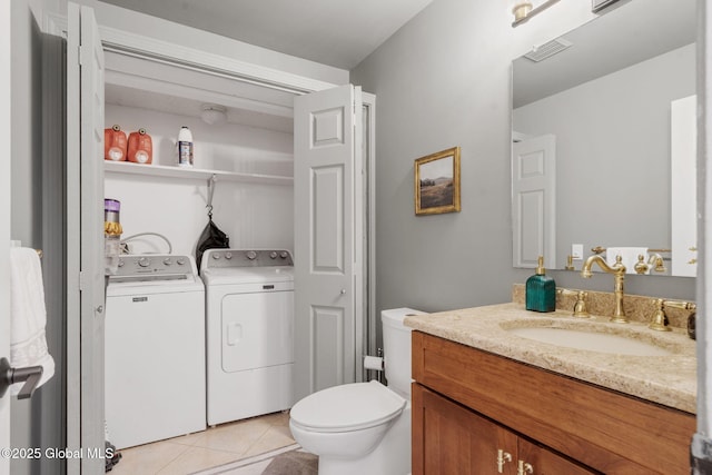 55 Journey Ln, Bethlehem, NY 12077 - bathroom featuring tile patterned floors, washer and clothes dryer, vanity, and toilet