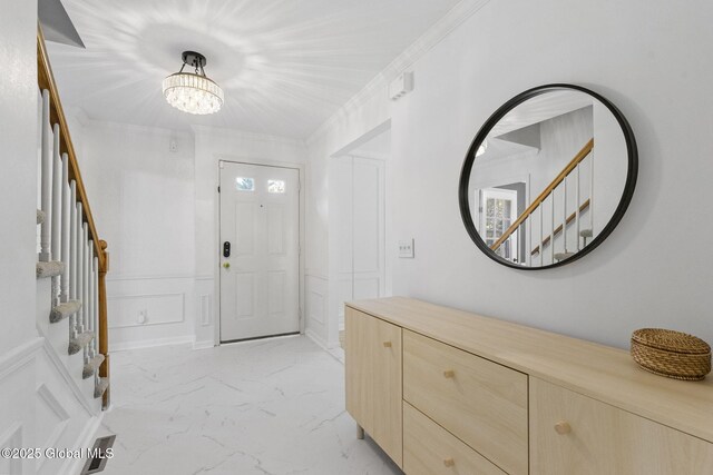 55 Journey Ln, Bethlehem, NY 12077 - entryway with stairway, light marble finish floors, a chandelier, a decorative wall, and wainscoting