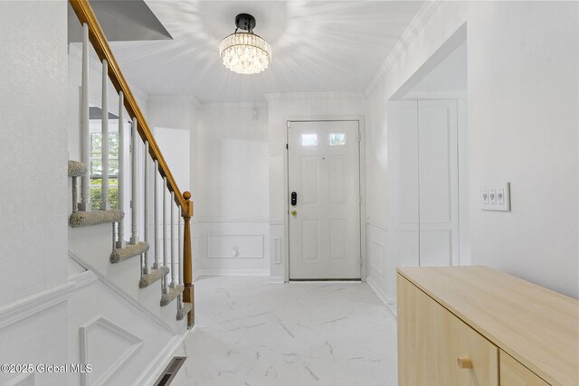 55 Journey Ln, Bethlehem, NY 12077 - foyer with a chandelier, stairway, a decorative wall, light marble finish flooring, and wainscoting