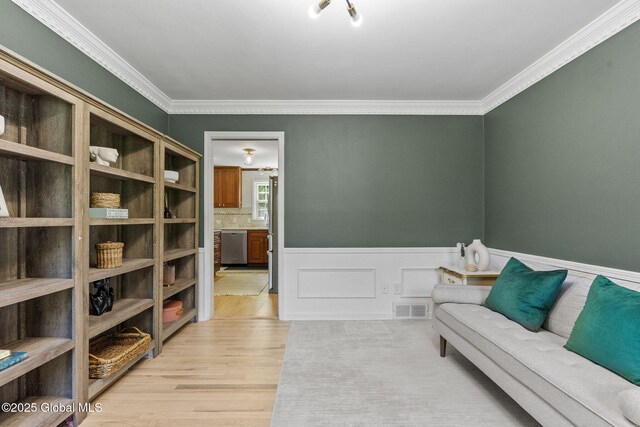 55 Journey Ln, Bethlehem, NY 12077 - living area featuring light wood-type flooring, crown molding, and a wainscoted wall