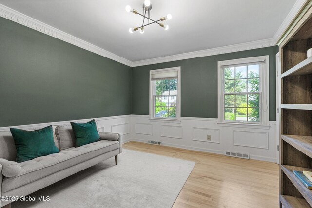 55 Journey Ln, Bethlehem, NY 12077 - sitting room featuring a chandelier, a wainscoted wall, ornamental molding, and wood finished floors