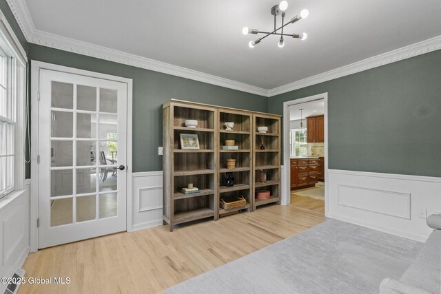 55 Journey Ln, Bethlehem, NY 12077 - sitting room with a chandelier, light wood-style floors, wainscoting, crown molding, and healthy amount of natural light