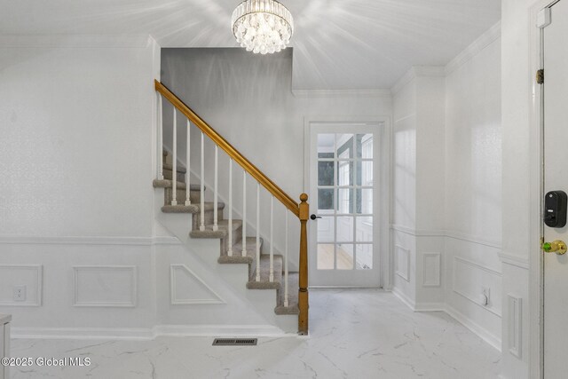55 Journey Ln, Bethlehem, NY 12077 - foyer featuring a decorative wall, a chandelier, crown molding, stairs, and wainscoting