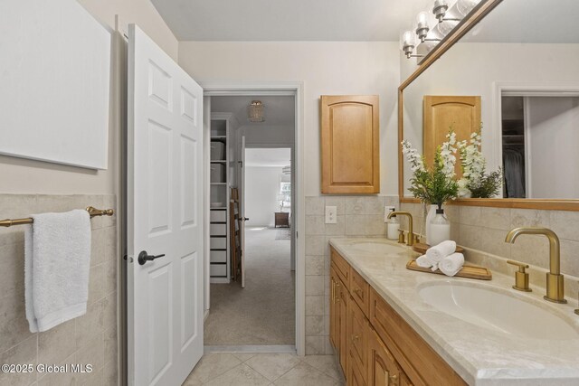 55 Journey Ln, Bethlehem, NY 12077 - bathroom featuring double vanity, tile patterned flooring, tile walls, and a spacious closet