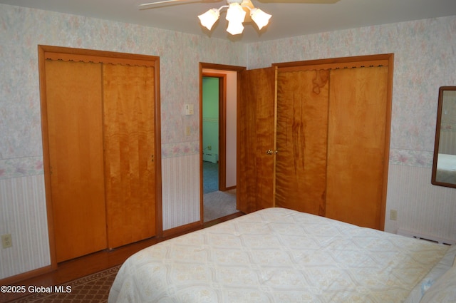 bedroom with wallpapered walls, ceiling fan, and a baseboard radiator