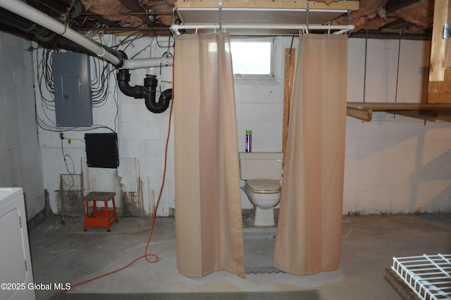 below grade area featuring electric panel and washer / dryer