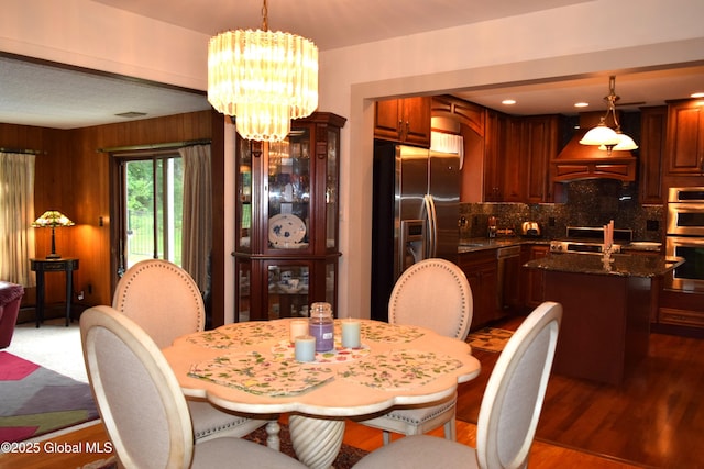dining area featuring a chandelier and wood finished floors