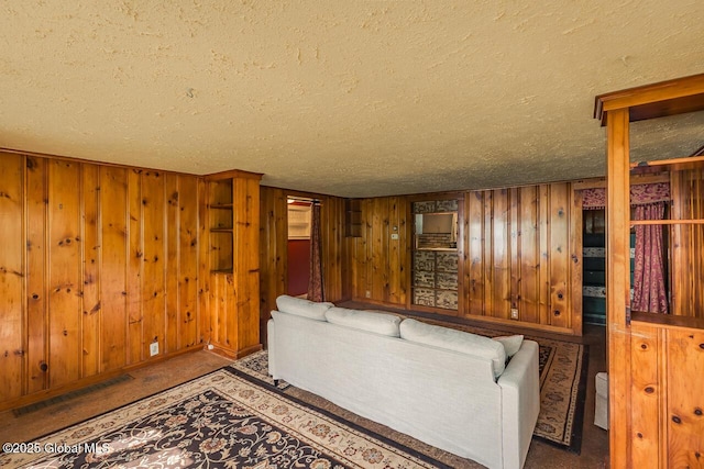 5518 Crooked St, Galway, NY 12074 - living room featuring a textured ceiling, wood walls, and baseboards